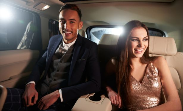 couple laughing at limousine