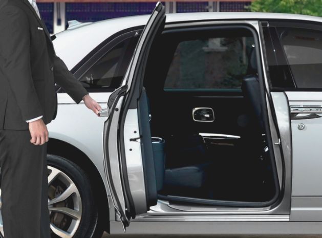 limo driver opening limousine door for passenger